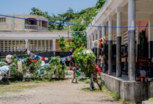 Photo of Desks become beds as Haitian school shelters people displaced by violence