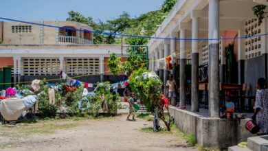 Photo of Desks become beds as Haitian school shelters people displaced by violence